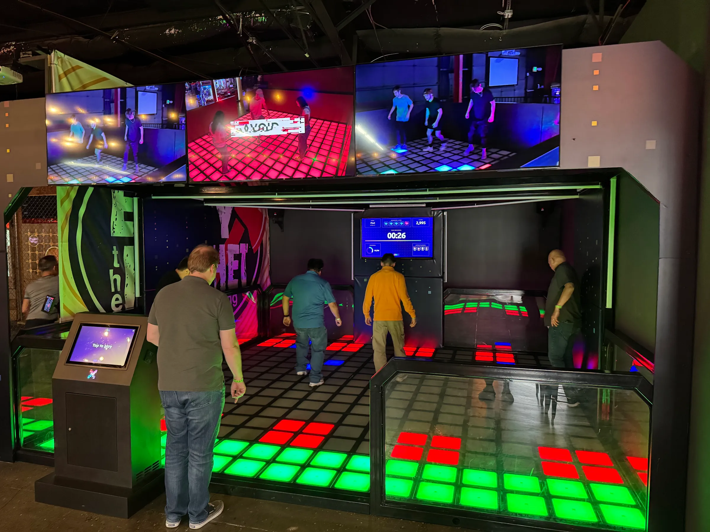 A group playing on the interactive Pixel Game Floor at Electric Sports Social