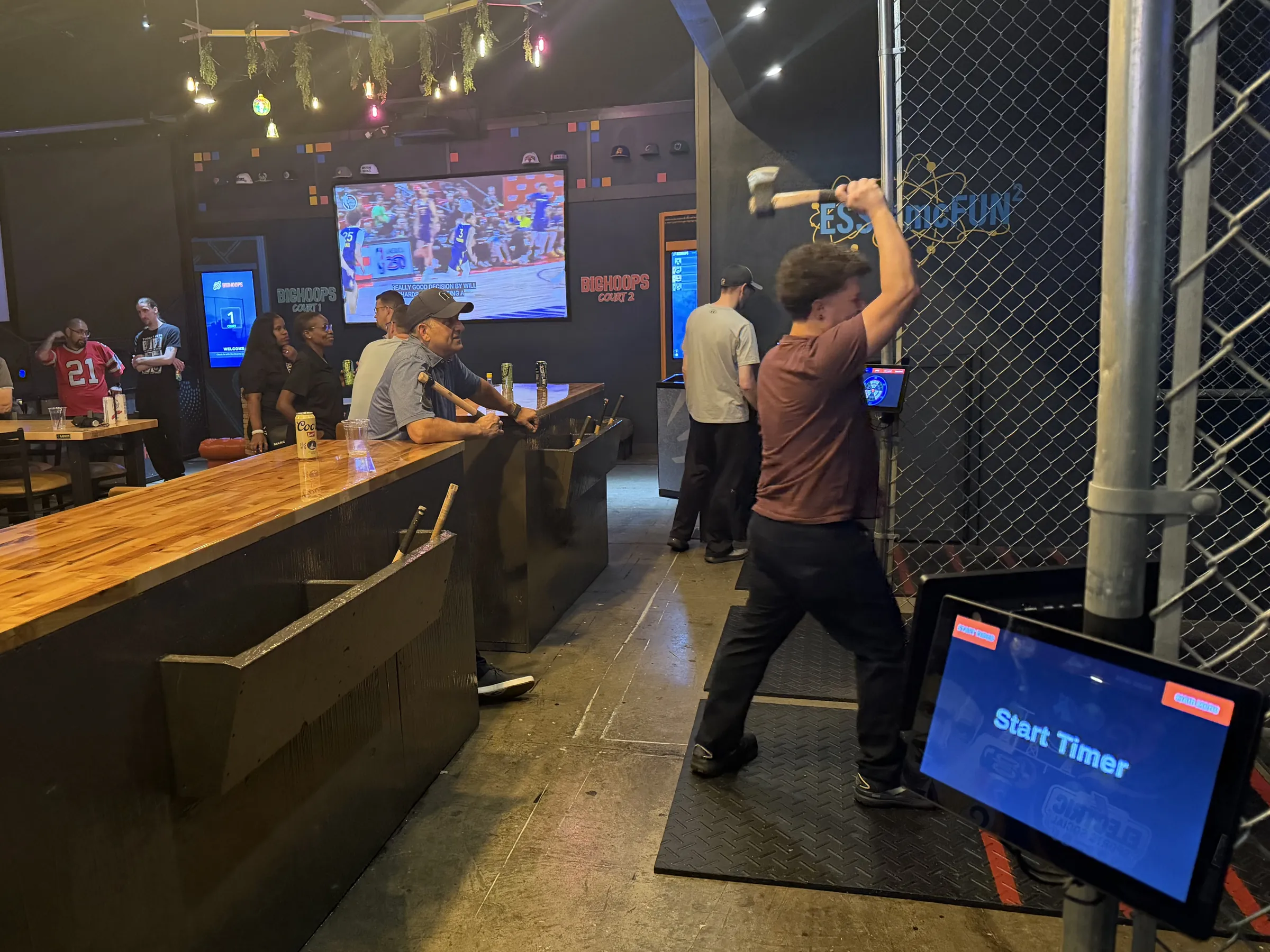 Players competing on the Smart Axes lanes at Electric Sports Social